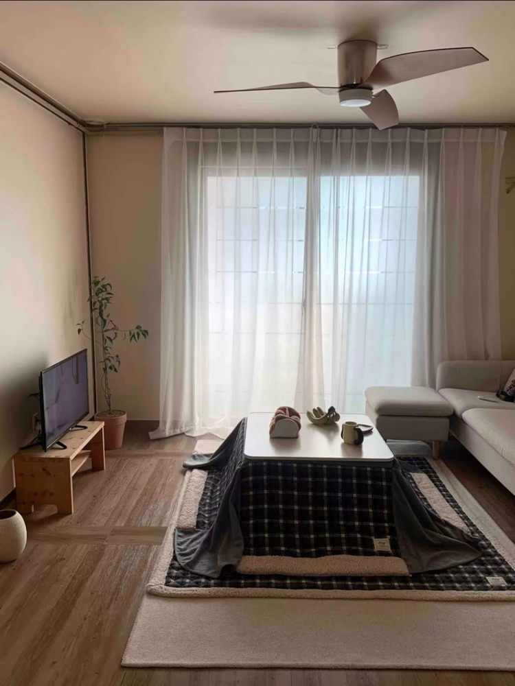 The living room with a ceiling fan and seasonal winter kotatsu